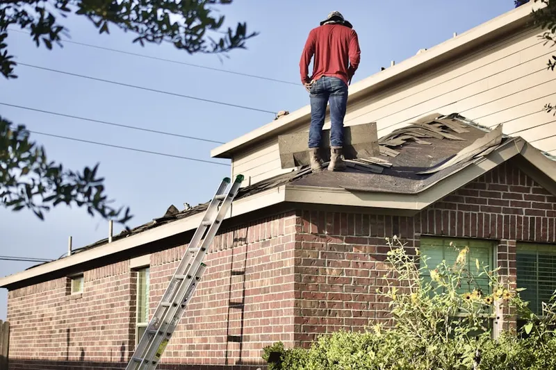 Professional roofer working on a residential roof in Monument Beach